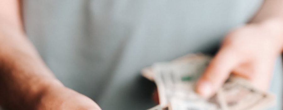 Free Crop man paying with American dollars Stock Photo