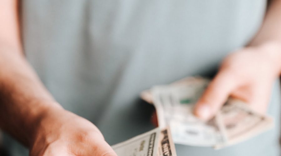 Free Crop man paying with American dollars Stock Photo