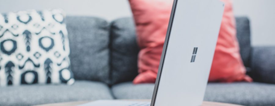 macbook pro on white couch