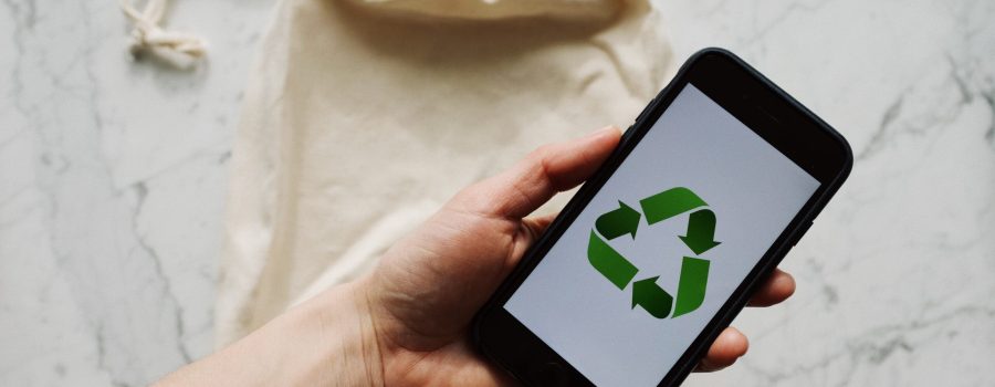 Free Faceless person showing recycle symbol on mobile phone screen Stock Photo