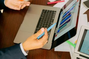 Free A Person in Black Suit Holding a Pen Stock Photo