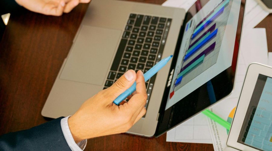 Free A Person in Black Suit Holding a Pen Stock Photo