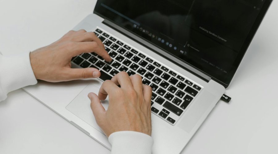 Free Hands on a Laptop Keyboard Stock Photo