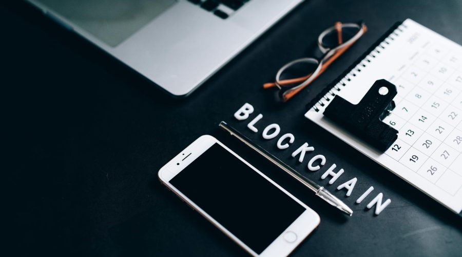 Free Flat lay of a modern digital workspace with blockchain theme, featuring a smartphone and calendar. Stock Photo